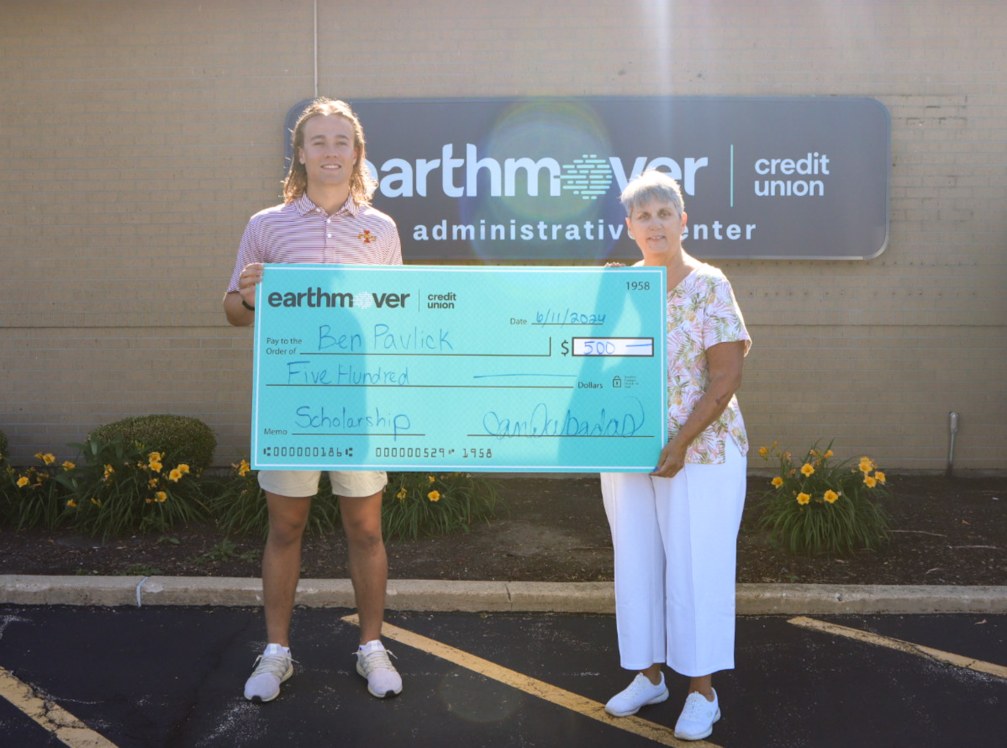 Student and woman holding giant check